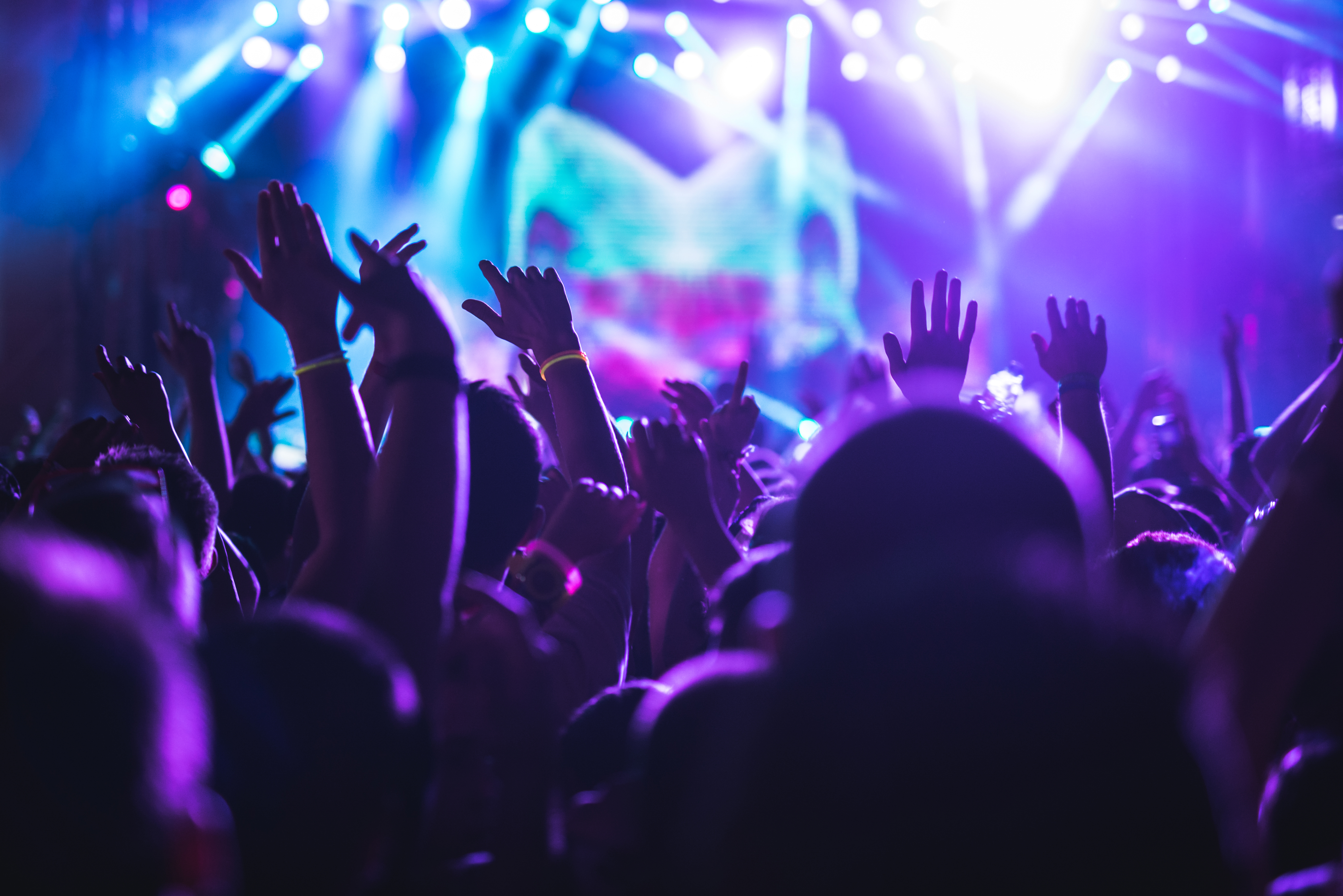 Adults partying at a rave with flashing lights