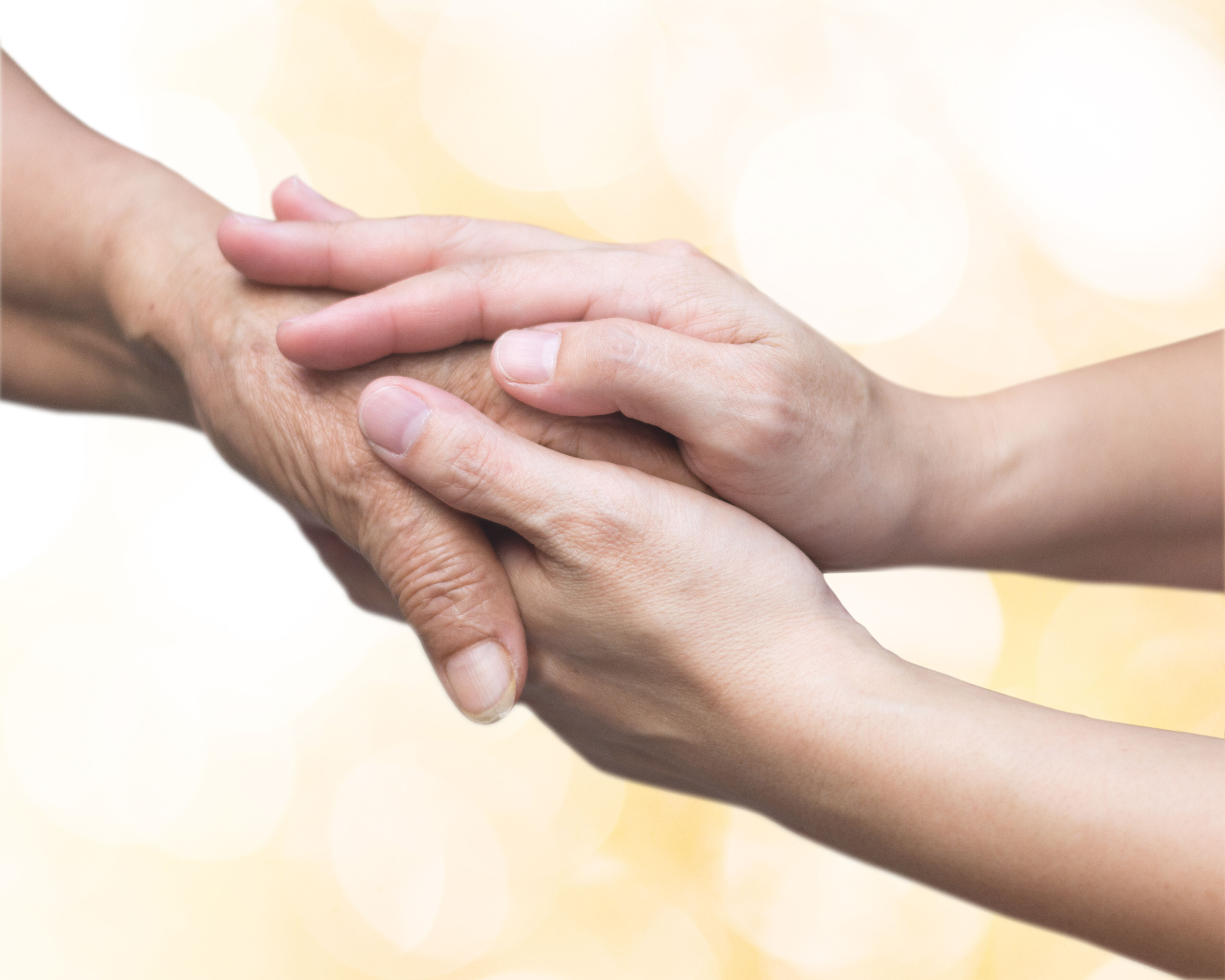 Caregiver, carer hand holding elder hand for hospice care. Philanthropy kindness to disabled old people concept with gold bokeh background.Happy mother's day.