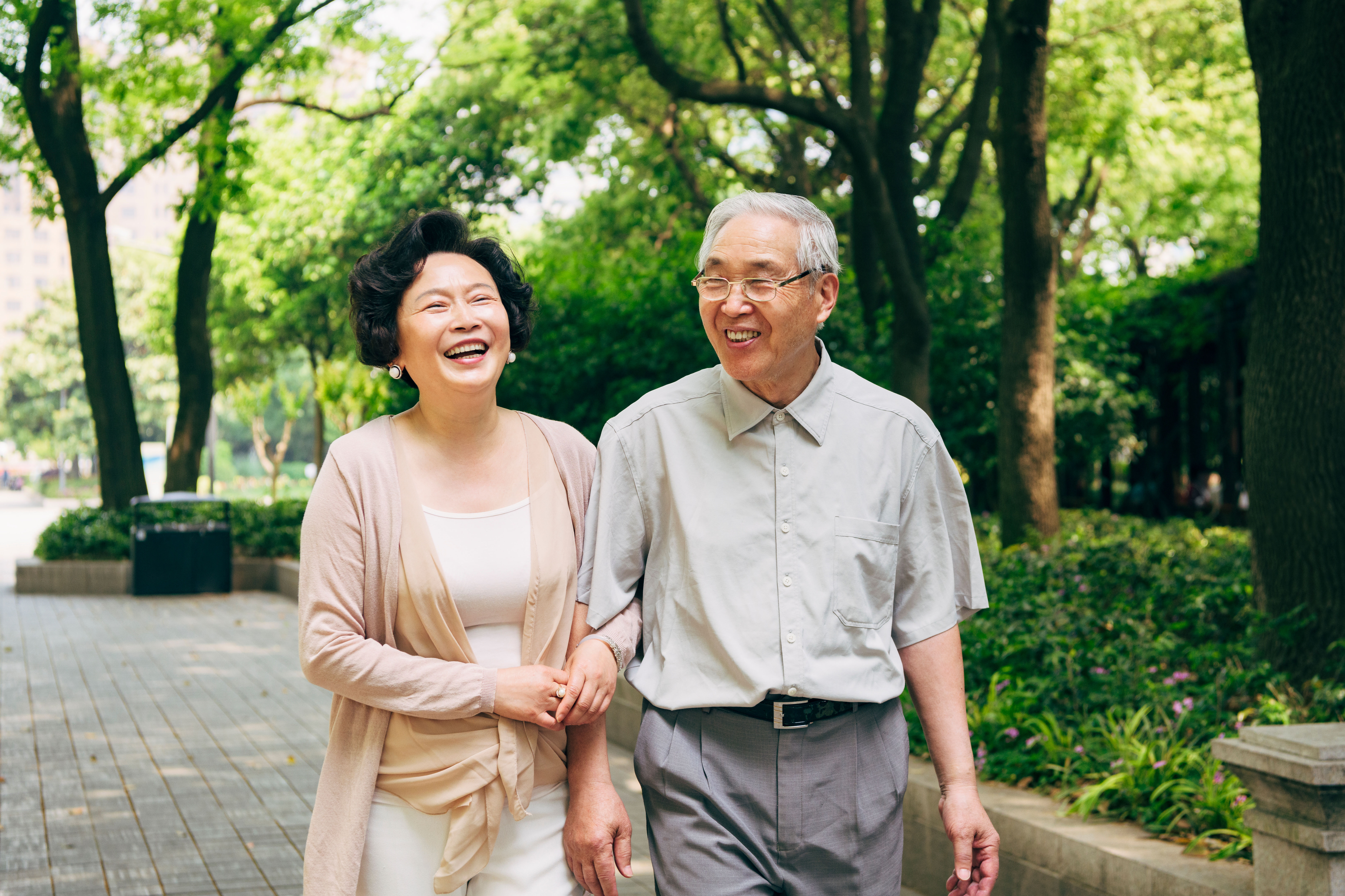 Lighthearted Chinese Seniors Walking at a Shanghai Park